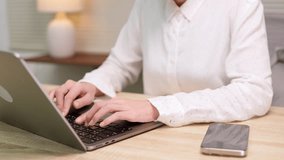 A person works on a laptop with holographic AI security icons and digital financial analytics charts, symbolizing fintech, data safety, and investment technology. - Powered by Shutterstock - Get 15% off with code: PIKWIZARD15