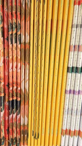 Colorful spines of stacked magazines form vibrant vertical pattern suitable for background use video