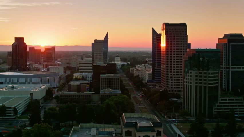 Sacramento skyline glows with the setting sun, casting a warm light on the city