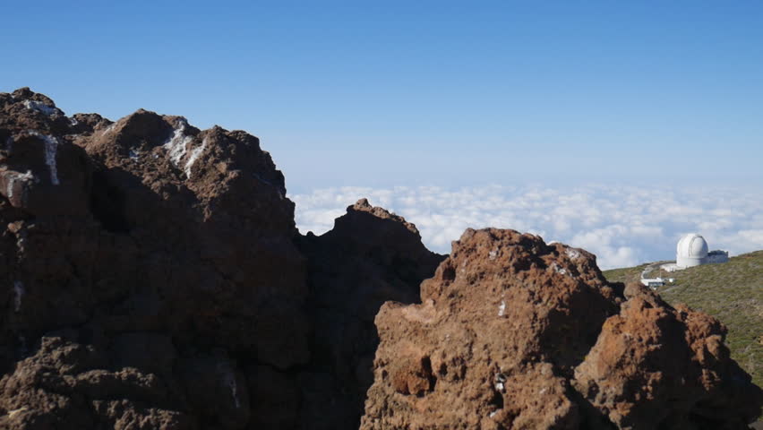 Telescopes of the Roque de los Muchachos Observatory on La Palma island above a sea of clouds