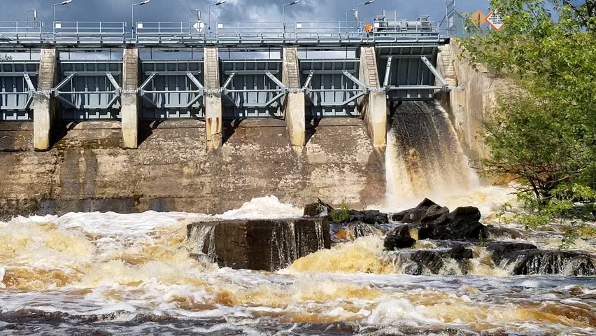 Powerful water pouring from the Pine River Flowage dam in Florence County, Wisconsin, creating turbulent rapids and showing the dramatic release of the river.