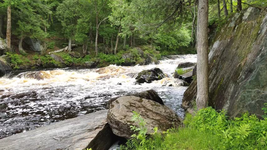 Meyer’s Falls waterfall cascading over rugged rock ledges in Florence County, Wisconsin, surrounded by lush forest scenery and flowing water in a natural setting.