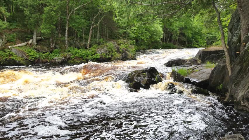 Meyer’s Falls waterfall cascading over rugged rock ledges in Florence County, Wisconsin, surrounded by lush forest scenery and flowing water in a natural setting.