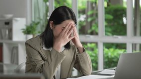 Young Asian Businesswoman looking stressed from work, Tired young businesswoman working at office - Powered by Shutterstock - Get 15% off with code: PIKWIZARD15