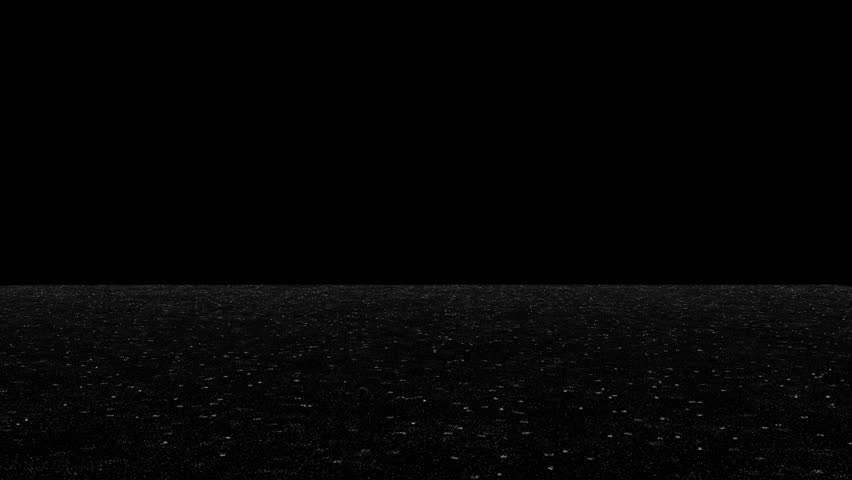 Rain falls on dark ground at night, creating ripples on wet surface. Moody, atmospheric, and dramatic shot for weather or cinematic scenes. Seamless loop with copy space above