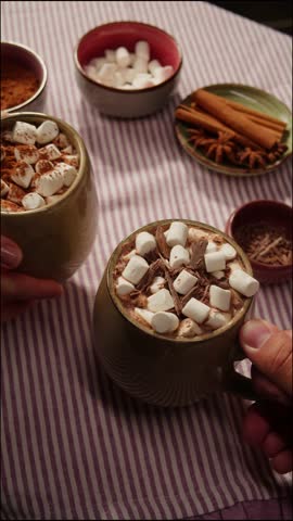 Making cocoa cacao hot chocolate with marshmallows. Man takes a spoon and mixing milk with cocoa powder. 