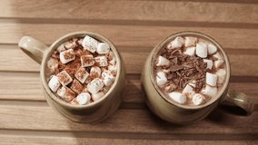 Making cocoa cacao hot chocolate with marshmallows. Man takes a spoon and mixing milk with cocoa powder.  - Powered by Shutterstock - Get 15% off with code: PIKWIZARD15