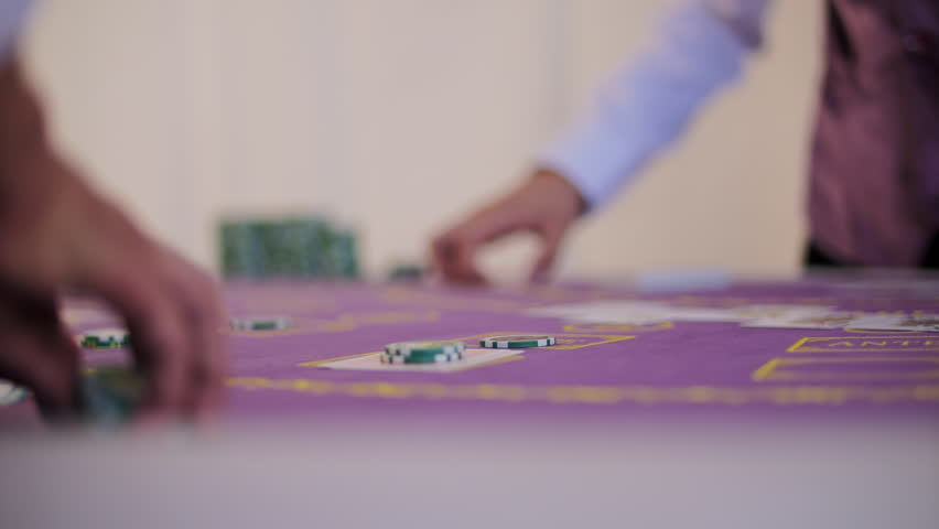 Hand flipping card on casino table
