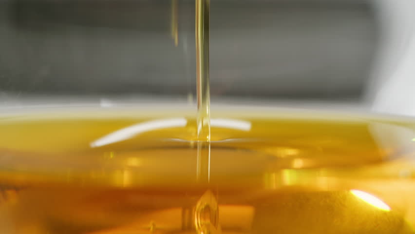 Pouring olive linen oil sunflower in different dishes close-up. Using in cooking for frying foods or as a salad dressing omega 3. Olive oil is popular supplement for meals and salads. 