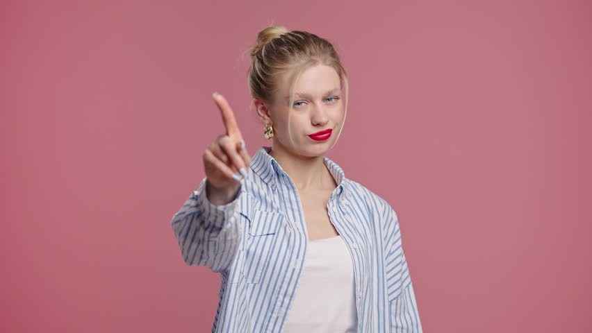 Uninterested Blonde Young Woman Disapproving With Stop Finger Sign. Dont Play