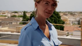 Female engineer in hard hat seen inspecting progress of construction site, smiling as walks through  unfinished building and supervises work being done - Powered by Shutterstock - Get 15% off with code: PIKWIZARD15