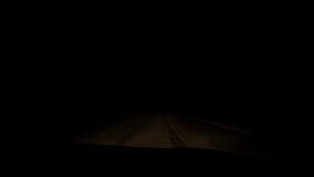 Vehicle approaching on a snowy road at night. Vehicle headlights piercing through dense snowfall, illuminating treacherous winter road conditions with stark visibility - Powered by Shutterstock - Get 15% off with code: PIKWIZARD15
