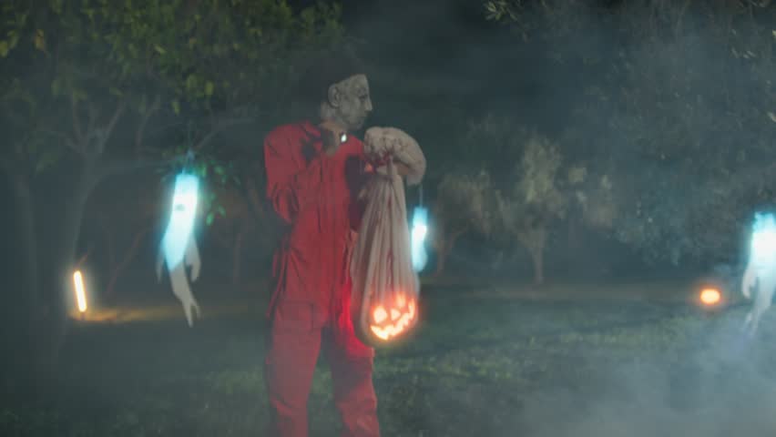 Halloween Monster Find His Victims With A Pumpkin In The Bag In The Foggy Forest