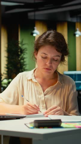 Vertical Video Corporate strategist ripping a paper after writing the wrong idea, restarting her work in rage and crumpling the page sheet, Discontent woman does a typo mistake while transcribing