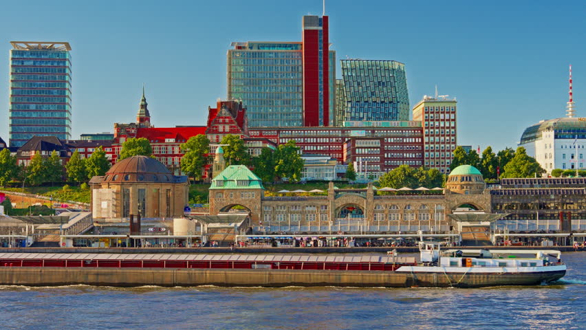 View of Hamburg's waterfront and citycenter and ships and boats passing along the Elbe River at sunset in Hamburg, Germany