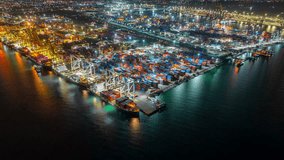 Aerial view hyperlapse container cargo ship international port terminal with gantry crane at night, Industrial cargo container port loading and unloading, Global business logistic import export. - Powered by Shutterstock - Get 15% off with code: PIKWIZARD15