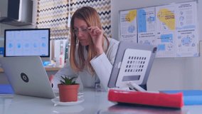Woman doctor in glasses types on laptop at medical office desk with folders and books. Modern healthcare, clinical work and digital data analysis. - Powered by Shutterstock - Get 15% off with code: PIKWIZARD15