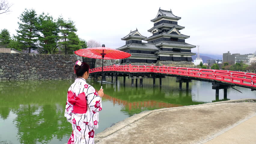 Asian woman wearing japanese traditional kimono at Matsumoto Castle, Nagano in Japan.