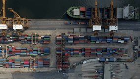 Aerial drone view industrial cargo container port with loading and unloading activity of ships by trucks and cranes. sea port container ships dock and unload imported and export goods. China Logistics - Powered by Shutterstock - Get 15% off with code: PIKWIZARD15