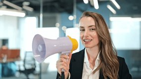 Successful businesswoman dressed in a suit, smiling cheerfully, holding a megaphone in a modern office. Professional female making an important announcement or calling attention. - Powered by Shutterstock - Get 15% off with code: PIKWIZARD15
