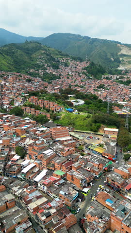 Aerial drone view of Medellin, historic hillside town in Colombia in daylight. Vertical