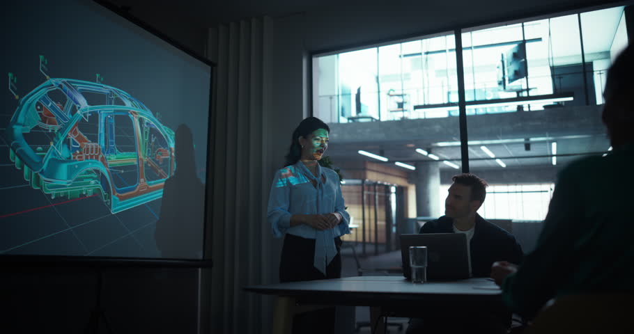 Multiethnic Businesswoman Explains Car Industry Innovations, Using a Large Display to Show a Modern Electric Vehicle Frame to a Group of Office Managers and Shareholders