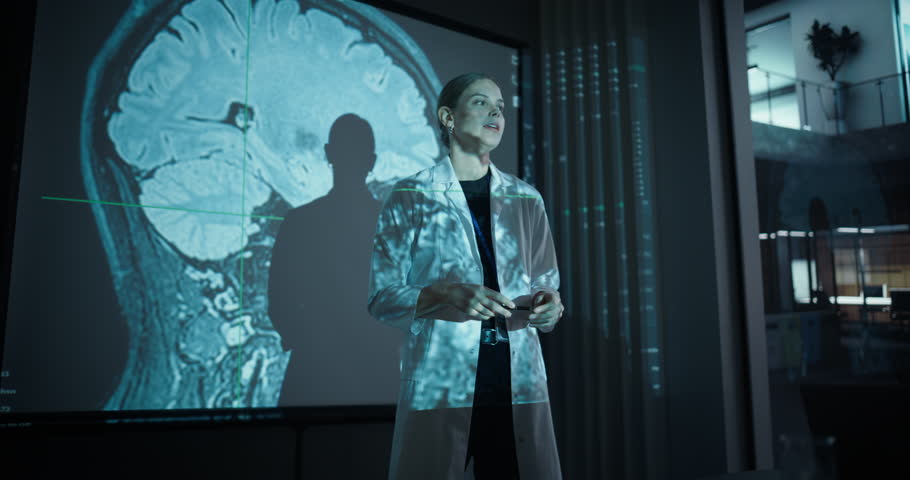 Female Doctor or Pharmacology Researcher in a White Coat Giving a Medical Presentation with Large Screen Visuals of Human Anatomy, MRI Brain Scan Data After Successful Treatment