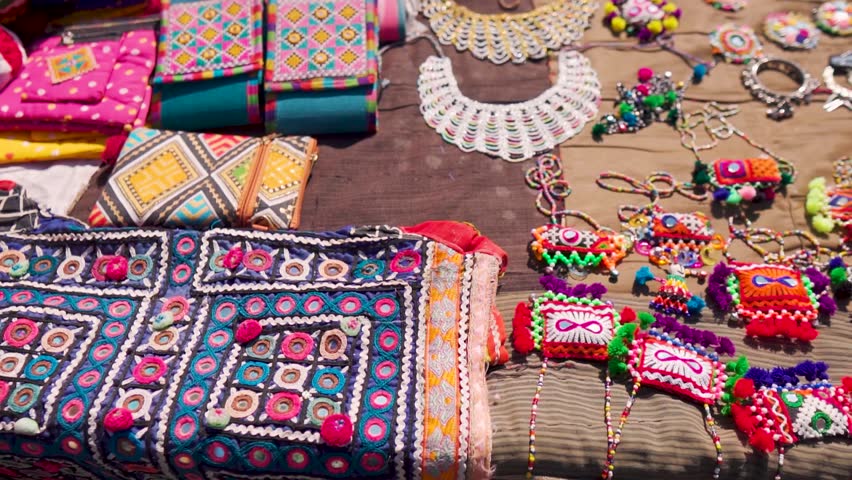 Close up shot of handicraft clothes, handbags and handmade jewelry from Rann Utsav market in Kutch, Gujarat, India. Beautiful Kutchi Handicraft arctician designer cloth in local street market. 