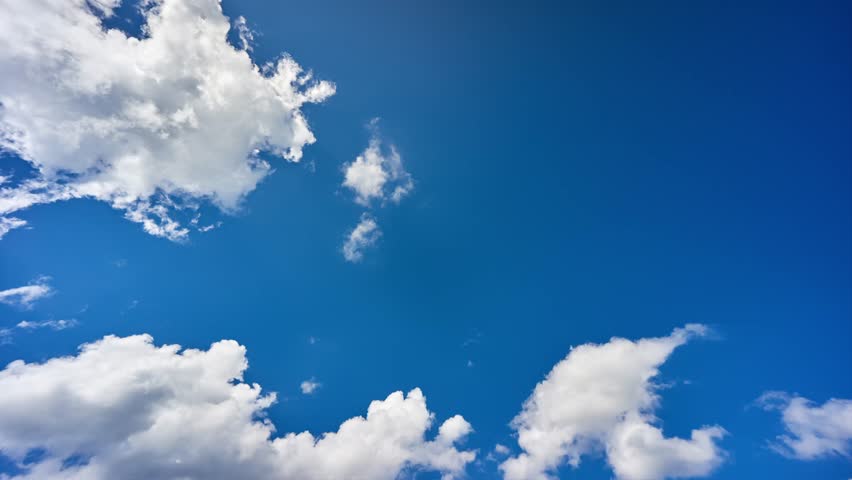 Timelapse of fluffy white clouds in a blue sky