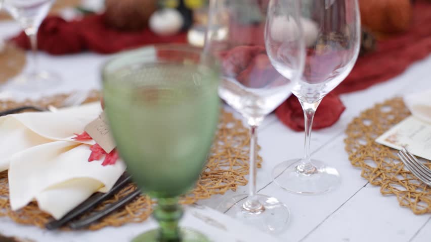 Slider shot of a fall themed place setting for an outdoor dinner.