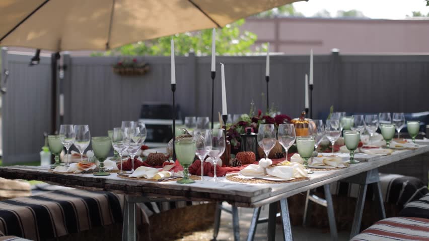 Slider shot of a fall themed outdoor dinner.