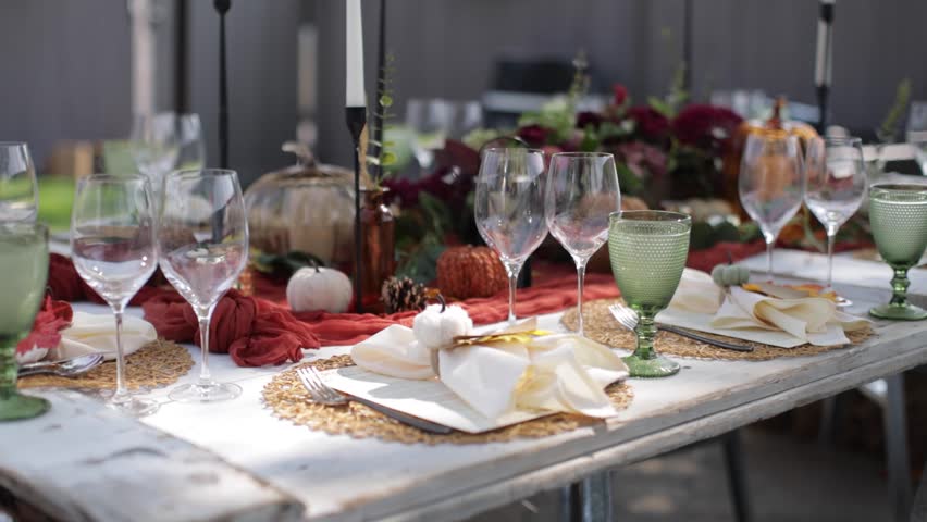Slider shot of a fall themed outdoor dinner.
