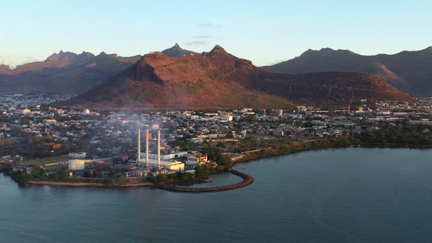 Aerial view of the city with buildings and mountains, juxtaposed against the calm waters of the sea, creating a scenic landscape, Port Louis, Port Louis District, Mauritius.