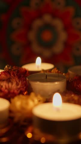 Lighting a Diwali golden ornament with candles for the traditional Festival of Lights