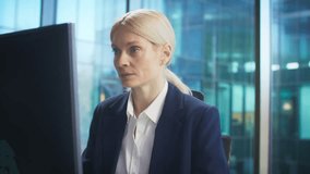 Asian businessman showing report on clipboard to seated businesswoman. People in formal suits discussing information on large monitor in bright modern office. Comparing data. Asking for help. - Powered by Shutterstock - Get 15% off with code: PIKWIZARD15