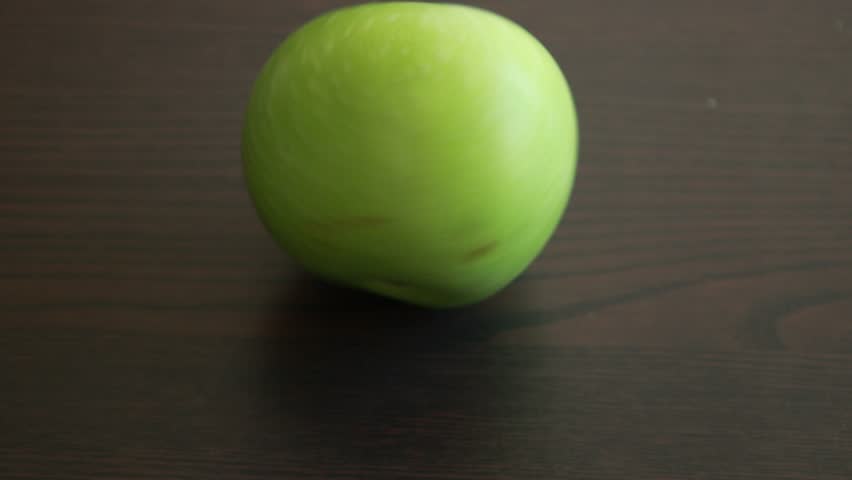 fresh green Granny Smith apple set against a dark background