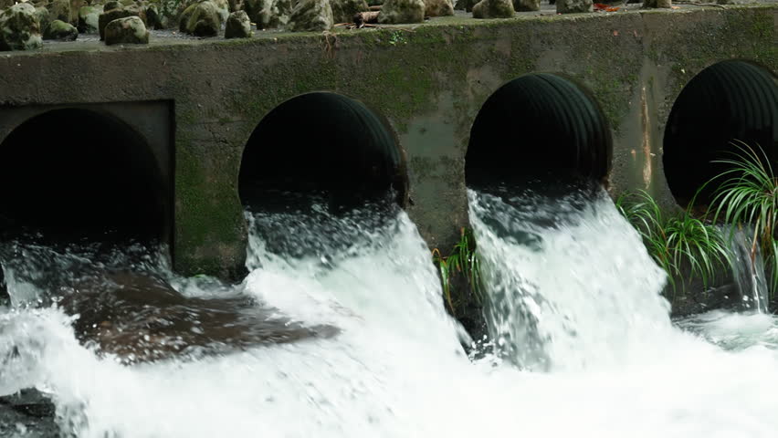 A concrete structure with water flowing from pipes