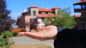 A real estate agent hands over the keys to a new apartment to a tenant. A successful apartment purchase or rental. A silver house-shaped keychain. Selling and buying a house. - Powered by Shutterstock - Get 15% off with code: PIKWIZARD15