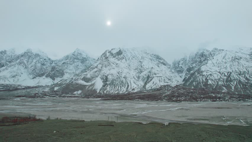 Beautiful drone view of snow capped mountains and highway in Gilgit Baltistan, Pakistan. Beautiful mountains, sun rising, cloudy weather, spa, nature, travelling, northern area of Pakistan, tourism. 