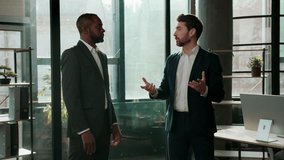 Two serious multiracial business men team businessmen talking in office company meeting multiethnic colleagues partners discuss work job deal Caucasian African American employers talk negotiation - Powered by Shutterstock - Get 15% off with code: PIKWIZARD15