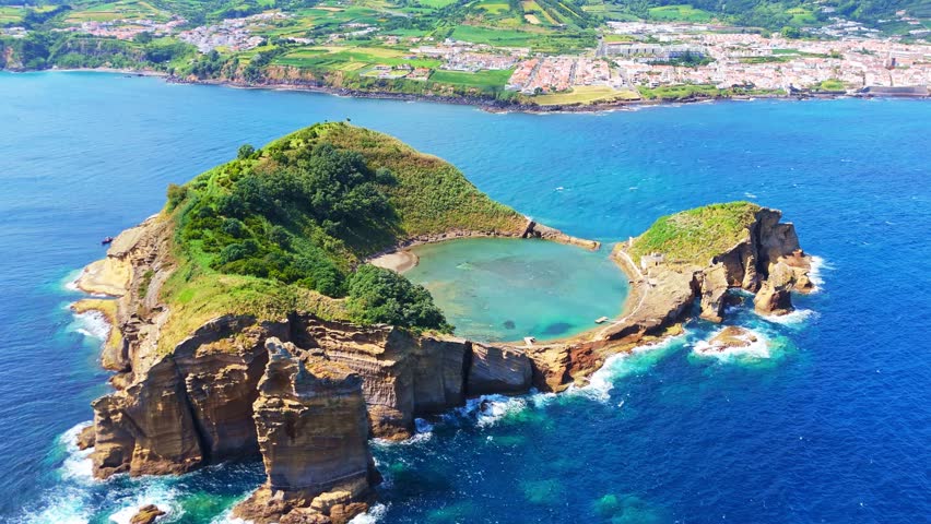 Green Vila Franca Islet and Atlantic Ocean on Sunny Day. Azores, Sao Miguel Island. Portugal. Aerial View. Drone Moves Forward, Tilt Down