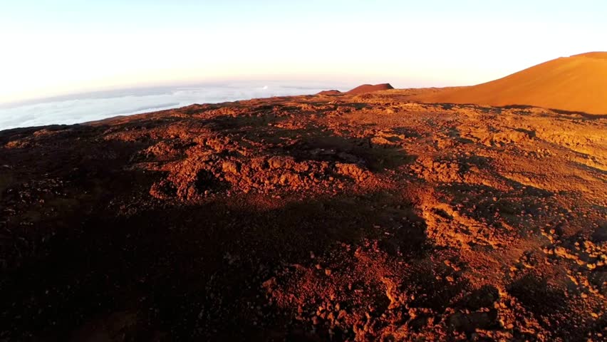 The sun rises over the rocky, volcanic landscape of haleakala national park