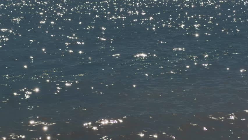 Shimmering water with sunlight surface. Gentle sea waves, soft sun light glimmers, tranquil atmosphere. Beautiful ocean background, nature peace. Sunset sunbeams on aquatic backdrop. Liquid ripples.