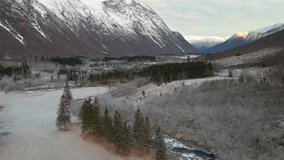 This 4K drone footage captures the snow dusted peaks, winding river, and serene forest landscape, offering a unique and captivating view of this iconic Scandinavian destination. Perfect for travel, na - Powered by Shutterstock - Get 15% off with code: PIKWIZARD15