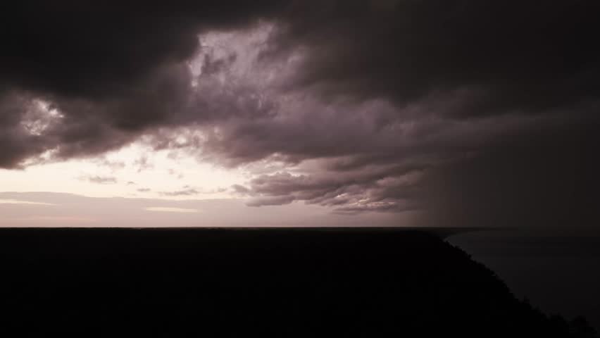 Dark dramatic clouds of coast horizon symbolizing extreme weather global danger