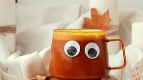 Adding whipped cream Funny halloween decoration face with eyes on cup of Pumpkin spiced latte morning warming coffee. Fall Drinks for Halloween Thanksgiving Holiday beverage Autumn spicy cinnamon - Powered by Shutterstock - Get 15% off with code: PIKWIZARD15