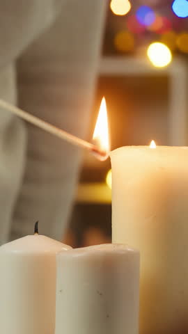 Woman decorating christmas tree. Young female student hanging balls and toys on evergreen tree in living room. Winter holidays concept, present box. Celebrating new year at home. 