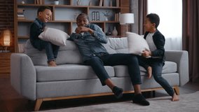 African American family at home play pillows fight father playing with sons little noise active boys naughty children on couch hyperactive kids having fun fooling around bad behavior dad stressed - Powered by Shutterstock - Get 15% off with code: PIKWIZARD15