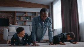 Happy African American family father coach push ups with sons boys little kids dad trainer coach teaching children doing sport workout in morning at home strong fitness enjoying childcare parenting - Powered by Shutterstock - Get 15% off with code: PIKWIZARD15