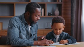African American family dad assists son with learning teamwork lovely schoolboy with father writing homework at home child kid boy with parent tutor tutoring distant education concentration study - Powered by Shutterstock - Get 15% off with code: PIKWIZARD15